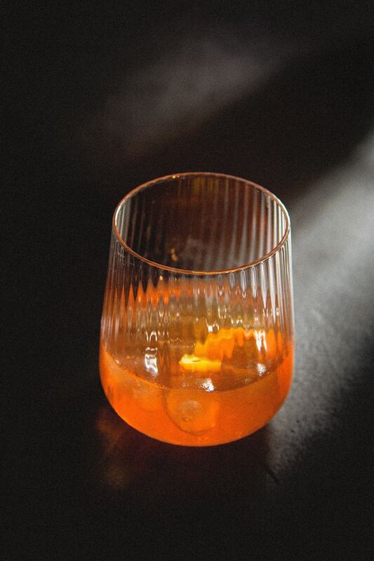 Aperol spritz in a ribbed tumbler, low light