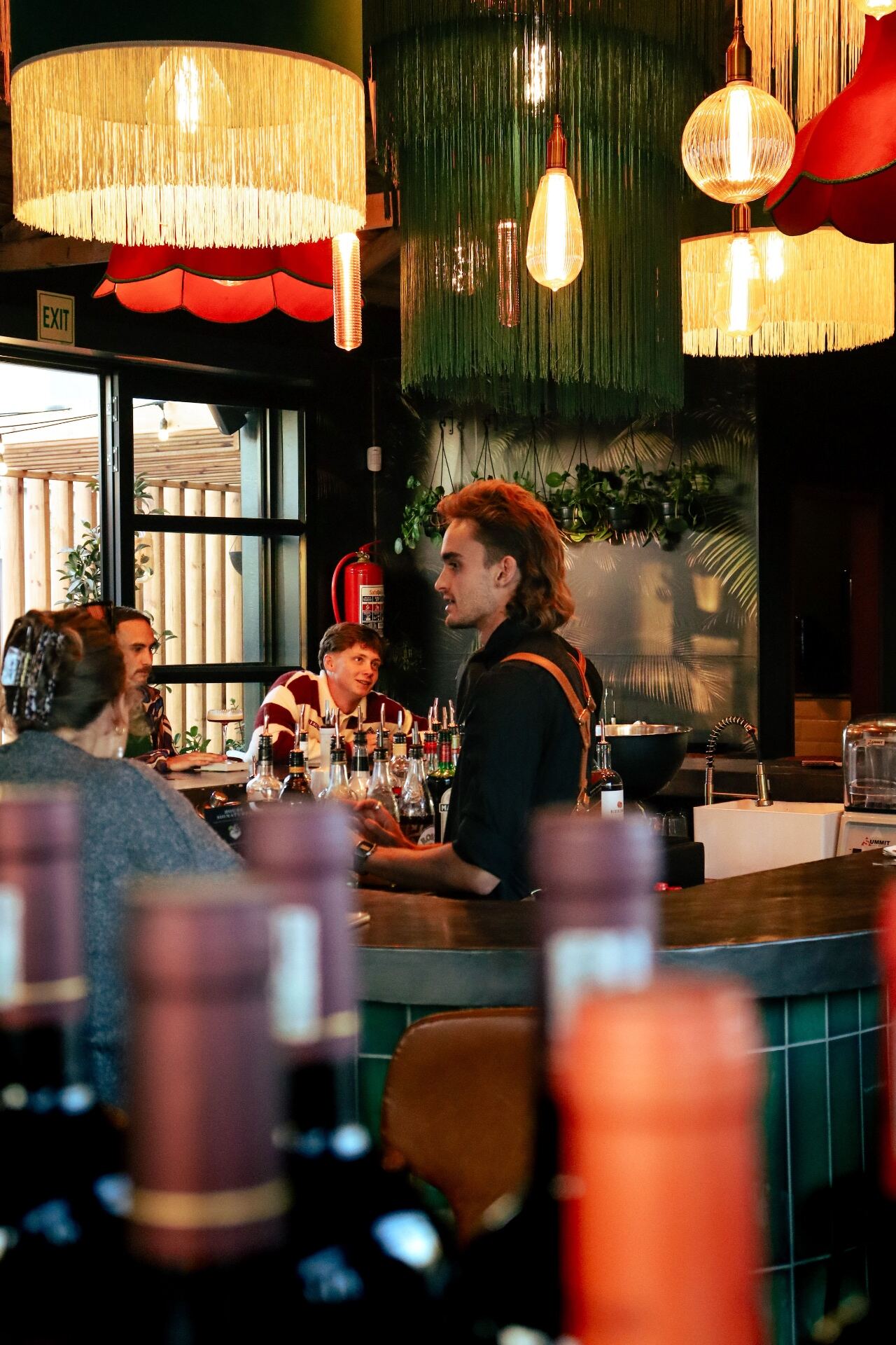 Bartender talking with guests across the bar