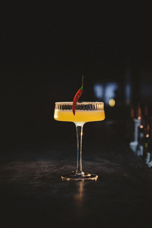 Spicy sour in a coupe with a red chilli